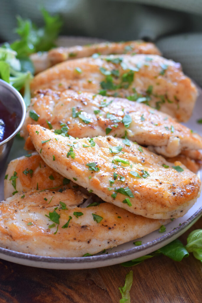 Close up of chicken tenders on a plate.