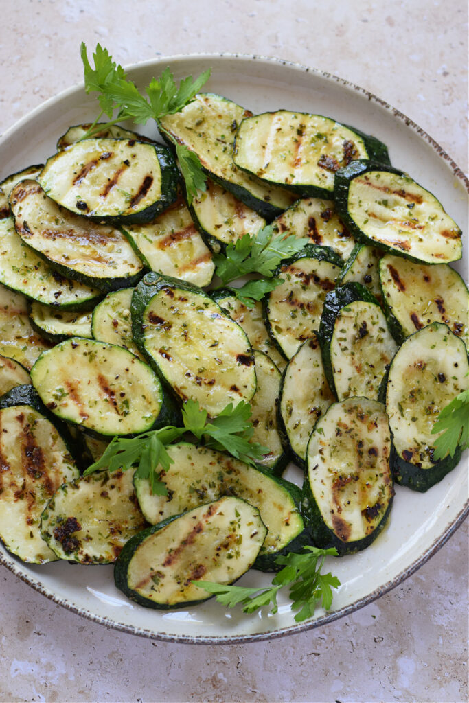 Grilled zucchini on a white plate.
