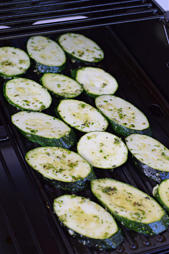 Cooking zucchini on a cast iron pan.