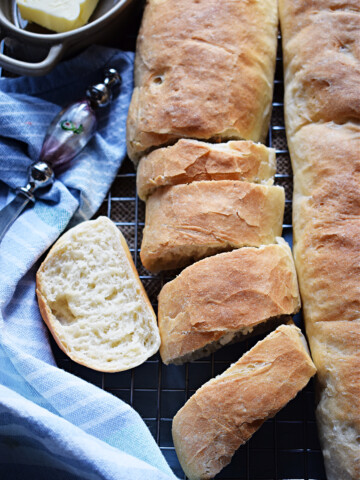 Sliced baguette bread on a tray.