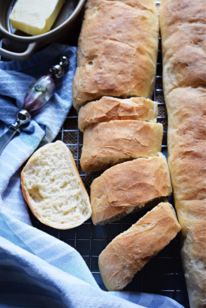 Sliced baguette bread on a tray.