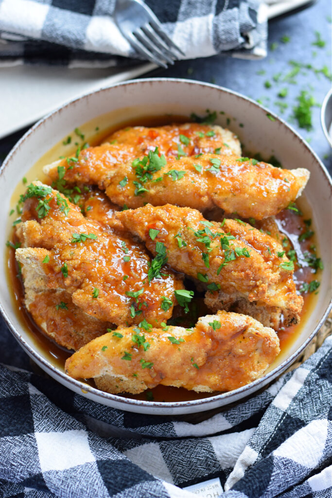 Honey garlic chicken tenders in a bowl.