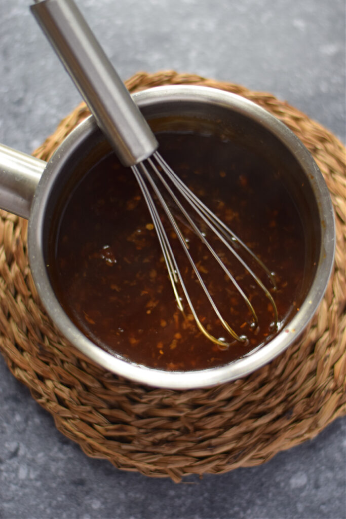 Making honey garlic sauce in a saucepan.