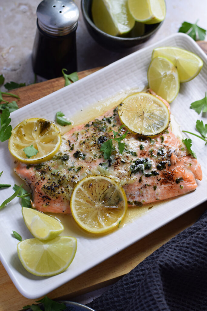 Baked honey lime salmon on a white plate.