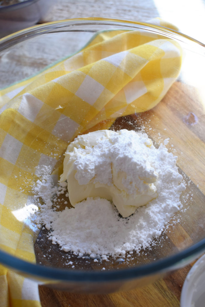 making a cream cheese filling in a bowl.