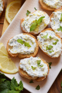 Bruschatta on a plate with lemon.