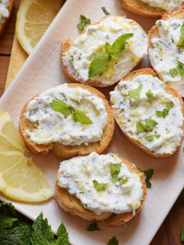 Bruschatta on a plate with lemon.