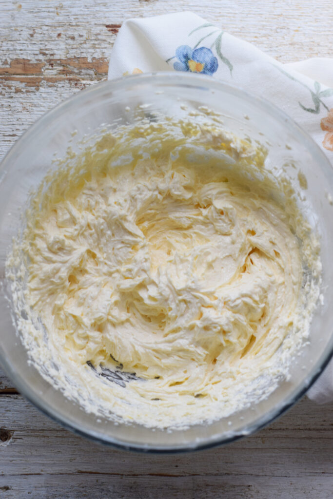 Making loaf cake batter in a glass bowl.