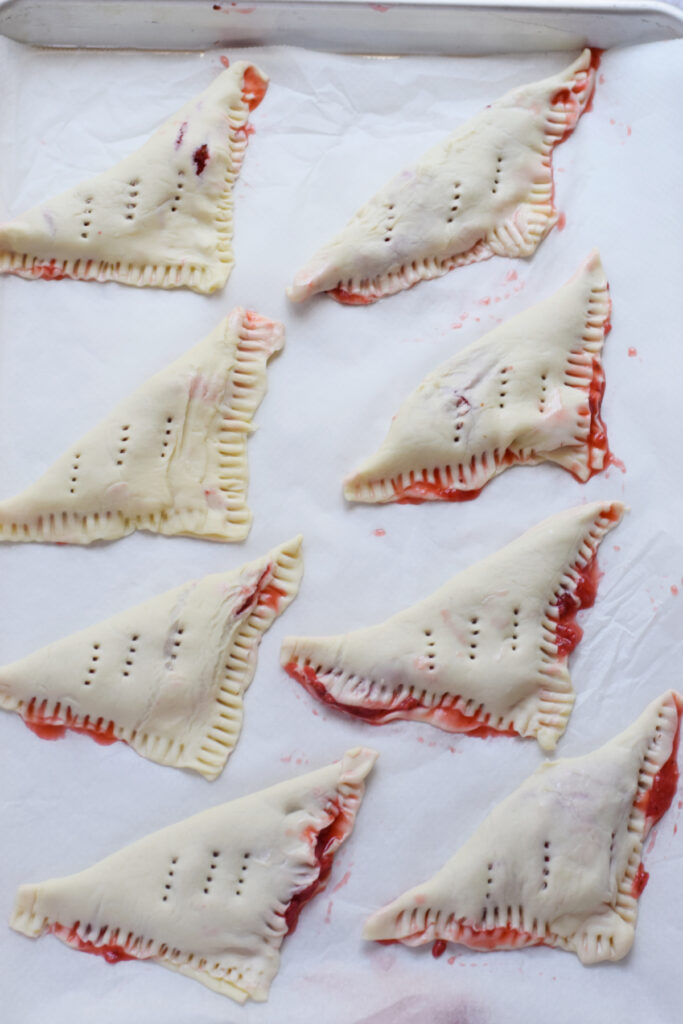 Ready to bake strawberry puff pastry squares.