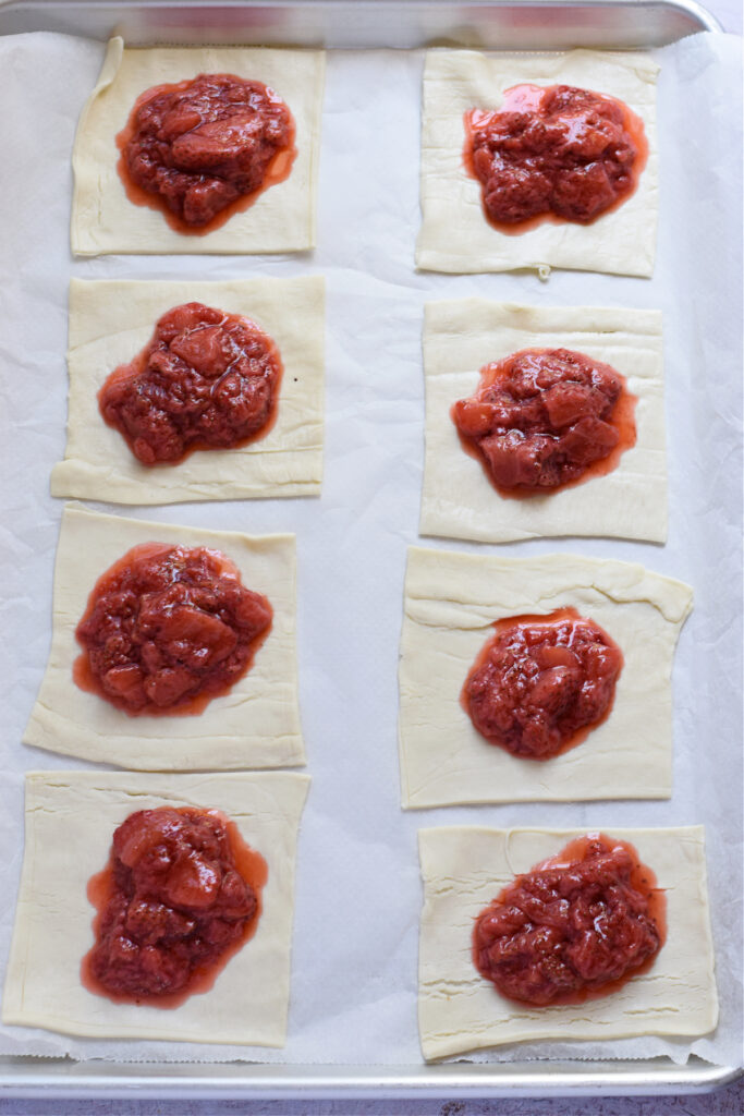 Making puff pastry squares with strawberries.