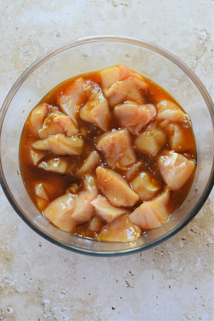 Cubed chicken in a teriyaki marinade.
