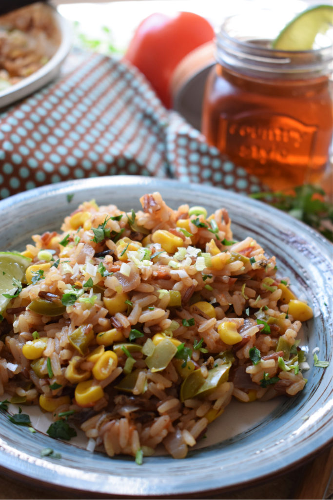 Rice on a plate with a drink in the background