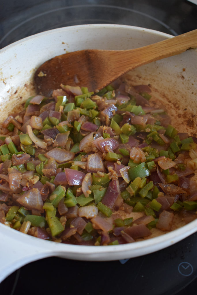 cooked vegetables in a pan to make the mexican style rice