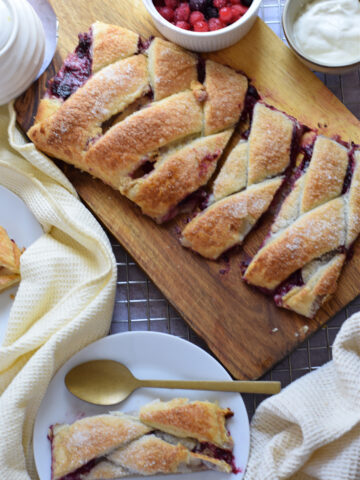 Danish on a wooden board and a slice on a plate.