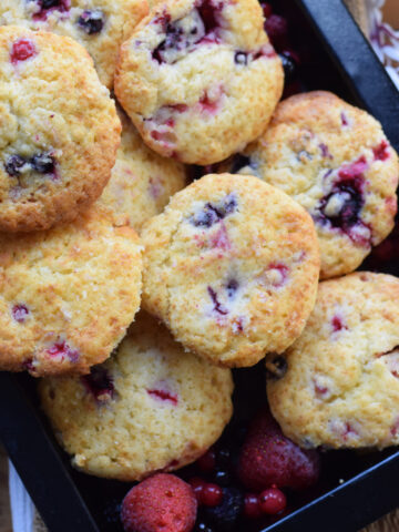 Berry muffins in a baking tray.