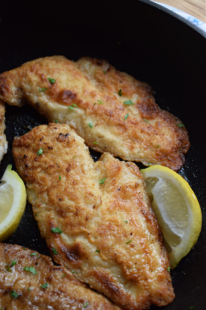close up of the crispy pan fried hake in a skillet