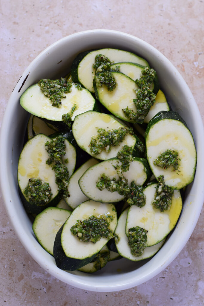 Zucchini in a bowl with marinade.