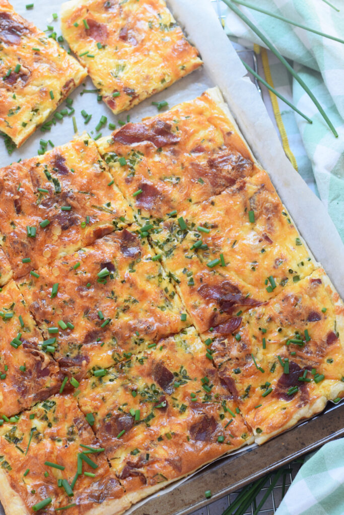 Sheet pan breakfast quiche on a baking tray.