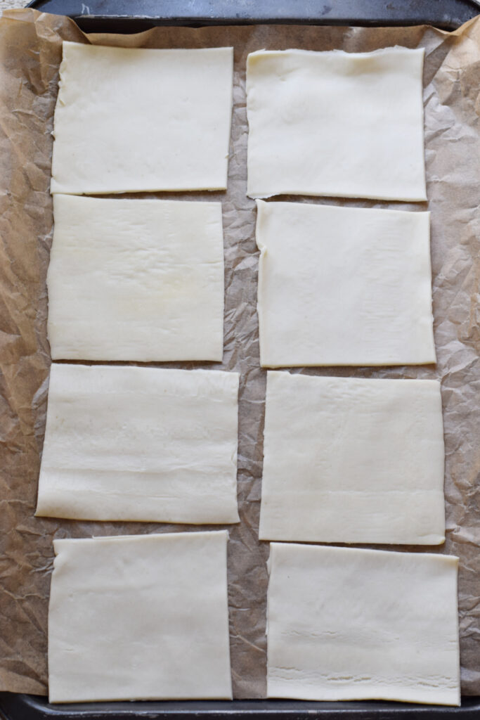 Pastry squares on a baking tray.