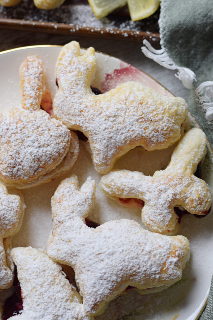 Close up of lemon blueberry filled puff pastry shapes.