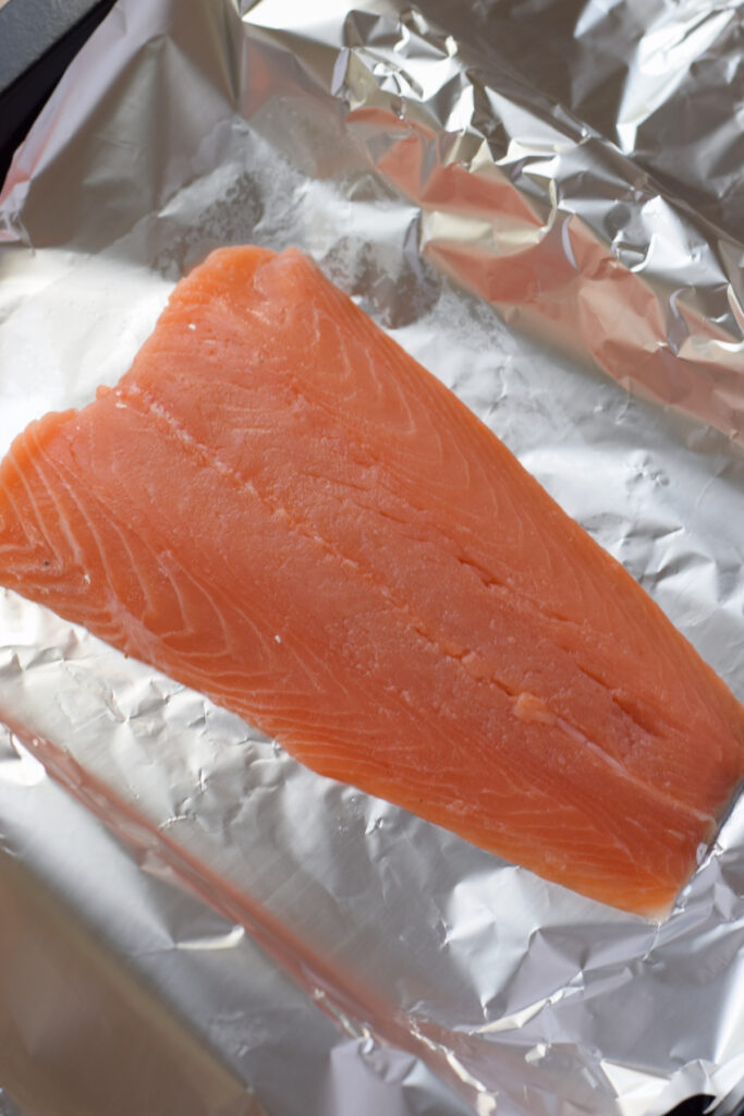 Place the salmon in a piece of aluminium foil.