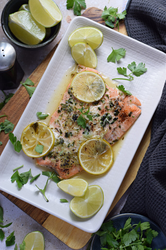 Baked honey lime salmon on a white plate.