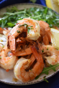 a pile of zesty lemon shrimp on a plate.