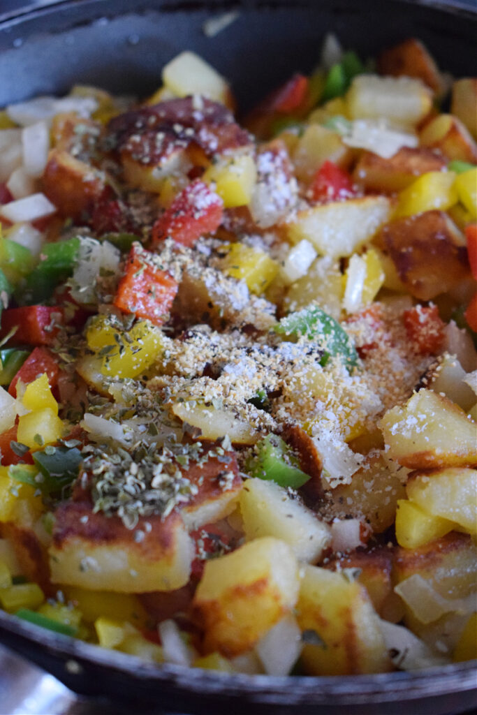 Adding seasonings to vegetables in a skillet.