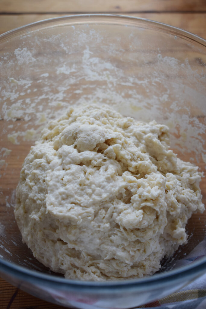 Dough in a glass bowl.