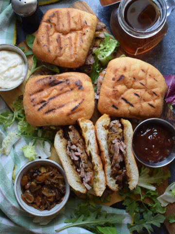 Steak sandwiches with cheese and onions.