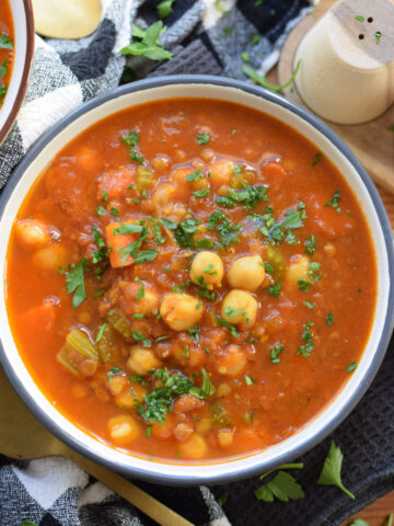 Spiced soup with chickpeas in a bowl.