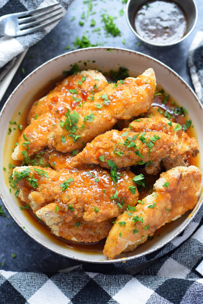Chicken tenders in a bowl.