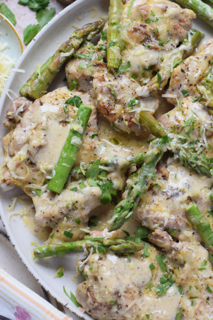 Close up of lemon chicken and asparagus.