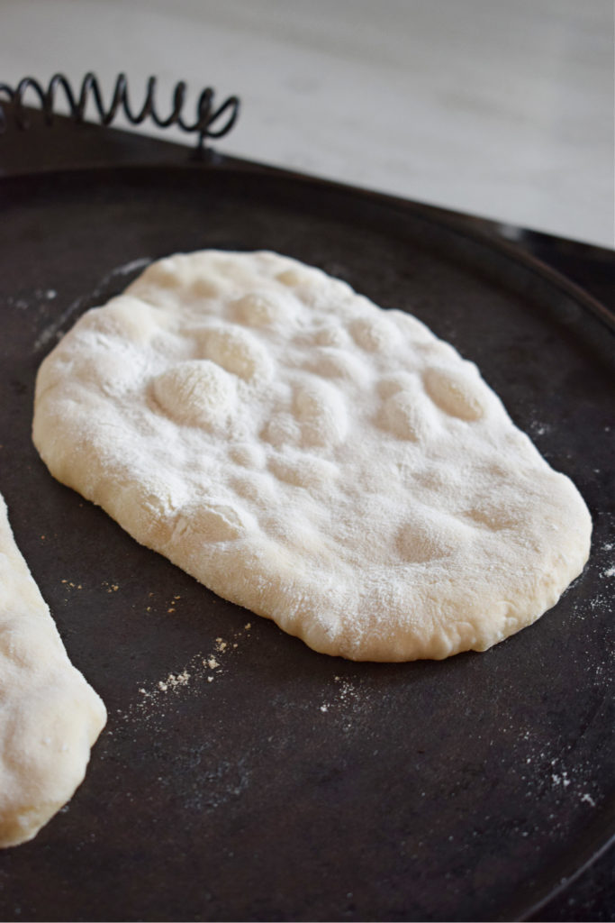 stove top nann bread cooking on cast iron