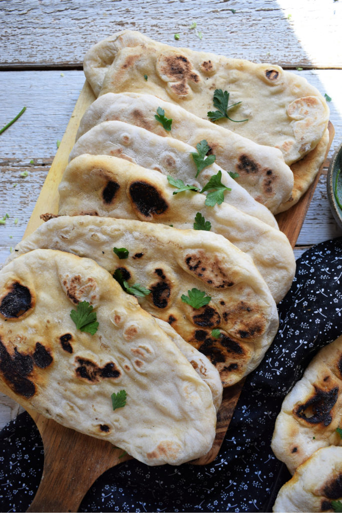stove top nann bread on a wooden board