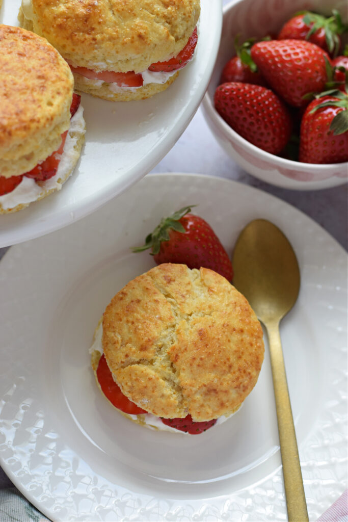 Close up of a strawberry cream scone on a plate.