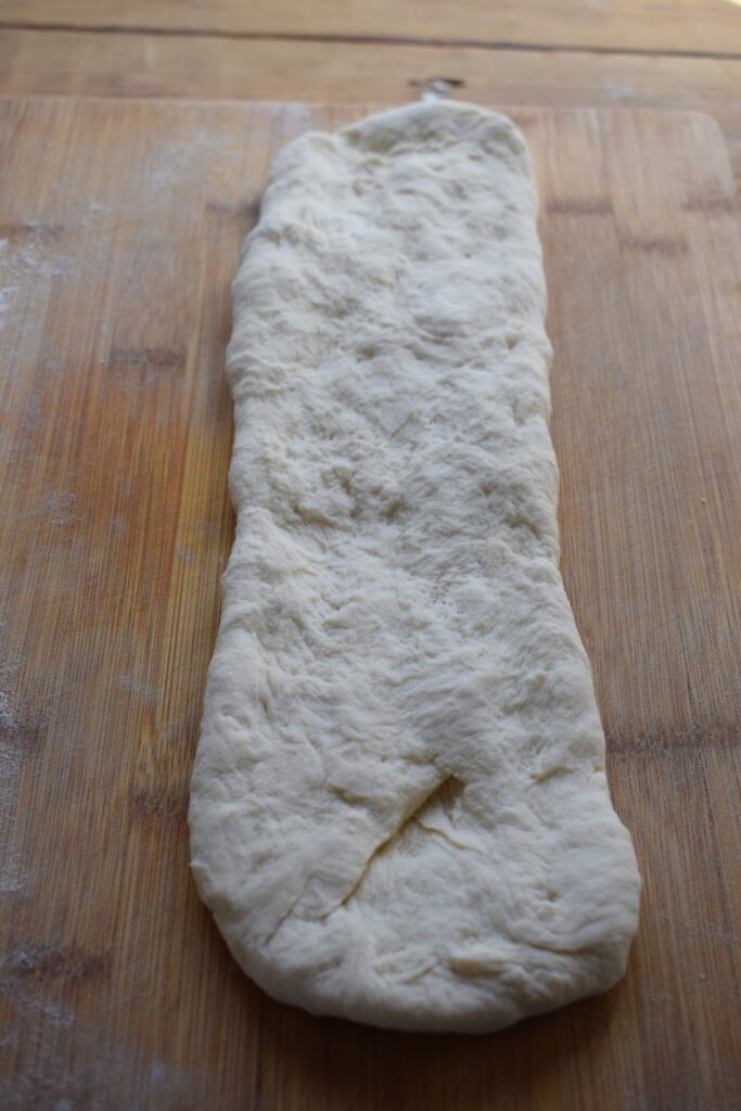 Making baguette bread on a wooden board.