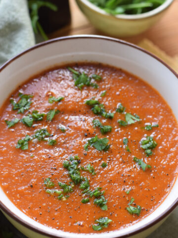 Close up of tomato and lentil soup in a bowl.