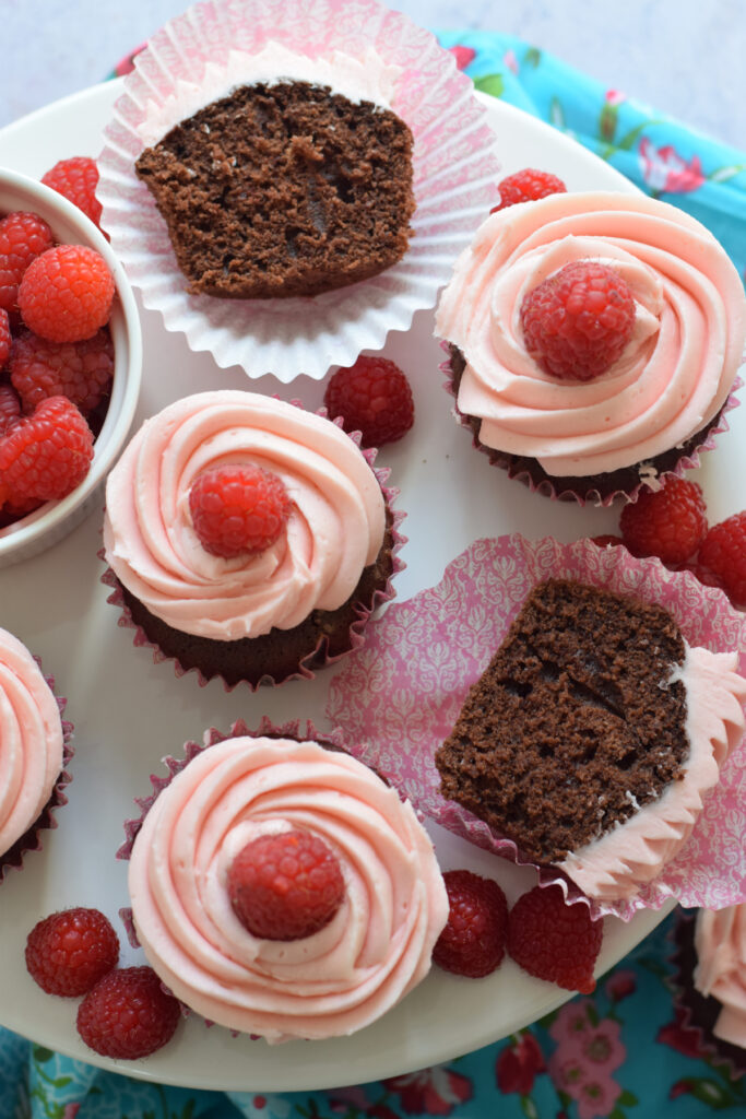 Chocolate cupcakes on a white serving plate.