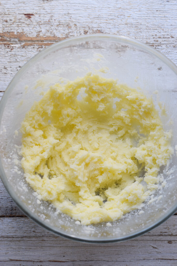 Mixed butter and sugar in a mixing bowl.