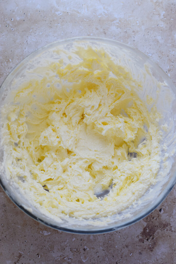Mixed butter and sugar in a bowl.